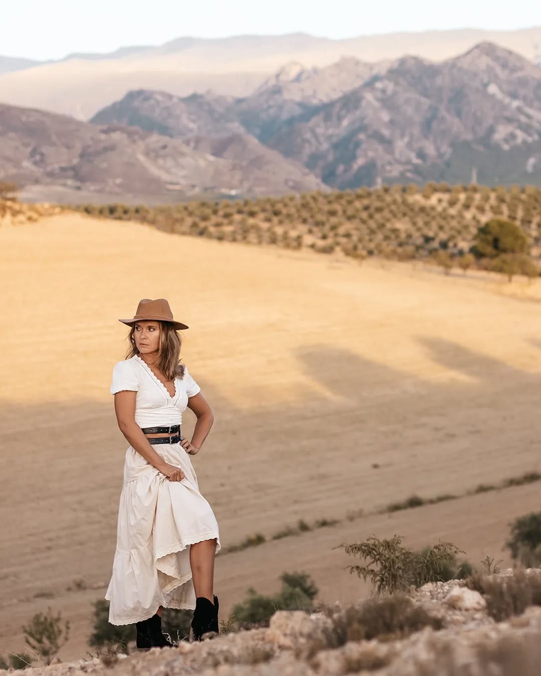 Silhouette of a person walking through a light-filled arch