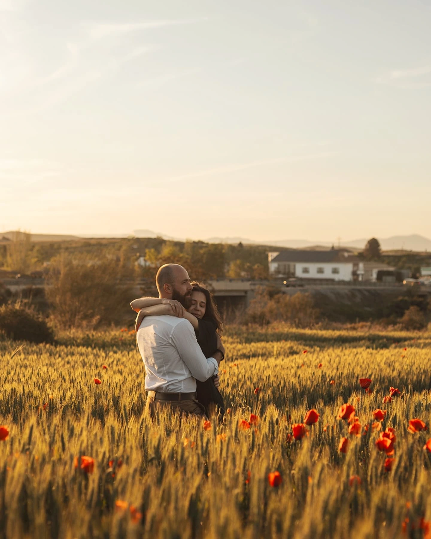 Portrait of woman in white dress in poppy field
